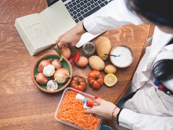 A scientist working with fruits and vegetables.