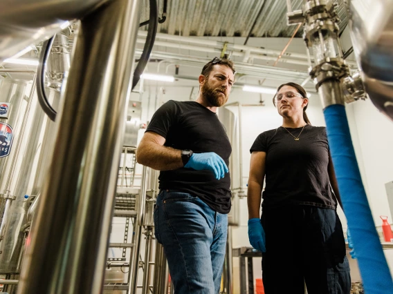 SNSW Head Brewer Patrick Heacock and fermentation science student Riley Helder work in the CALES Ales brewhouse at Cork & Craft.