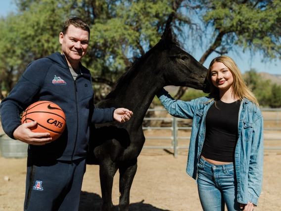 Picture of Coach Lloyd with weanling racehorse and his daughter