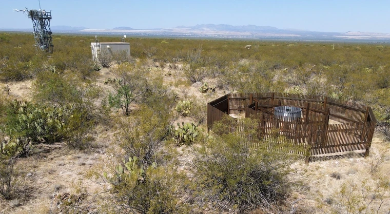 NEON’s Double Fence Intercomparison Reference gauge (foreground) and the instrument hut and flux tower.